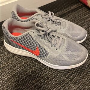 Nike Gray Sneakers with orange Swoosh